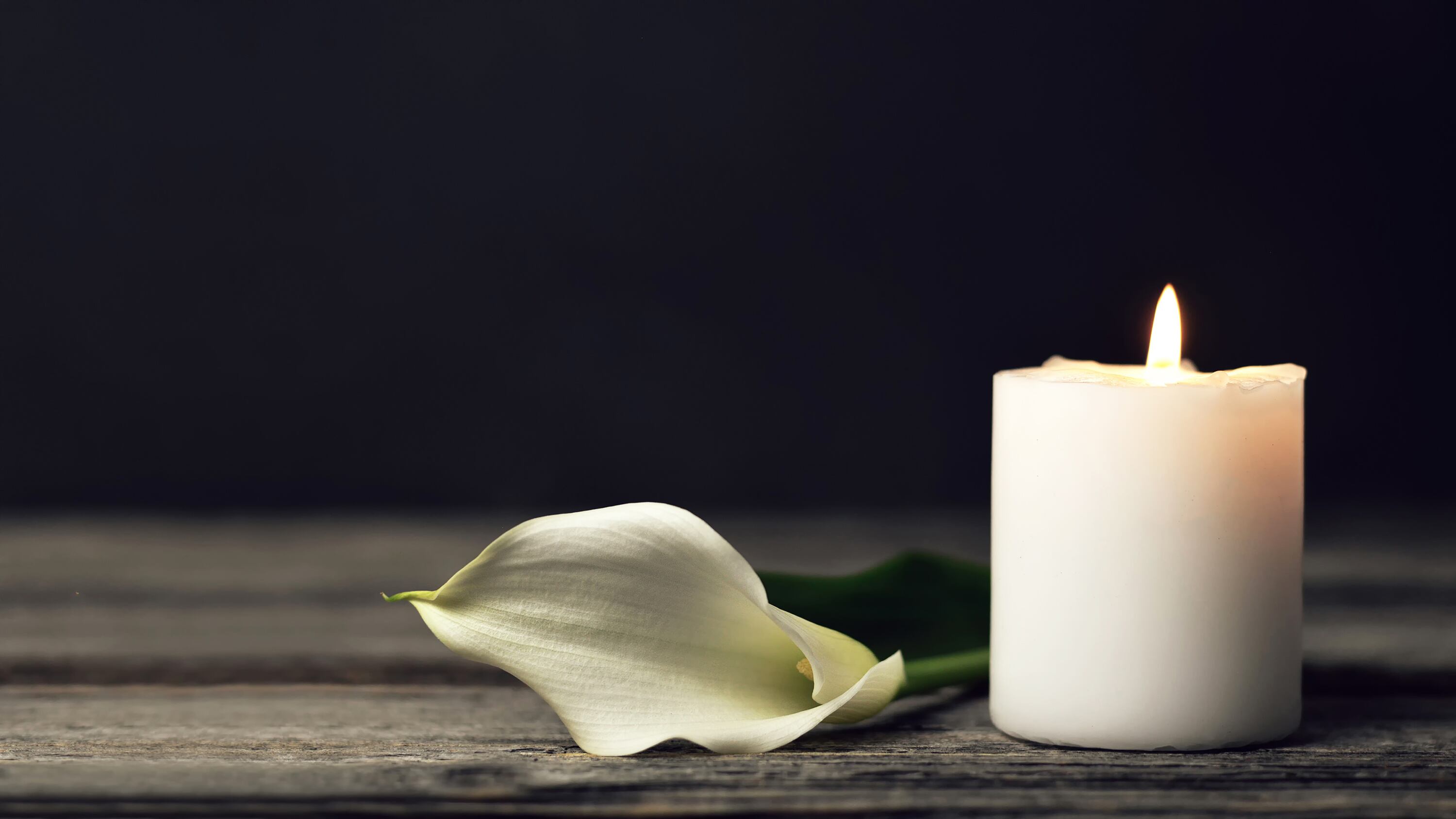 Burning candle and white calla